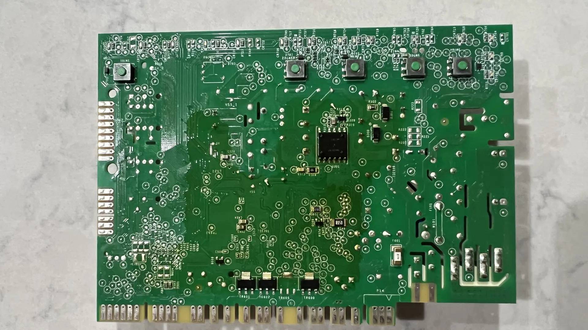 Back side of the control board showing all tactile switches with green caps and conformal coating